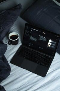 computer and coffee in bed